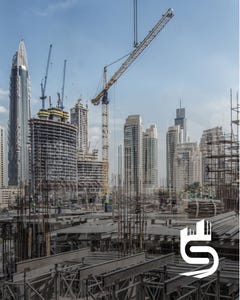 Construction site of a city skyline with cranes.
